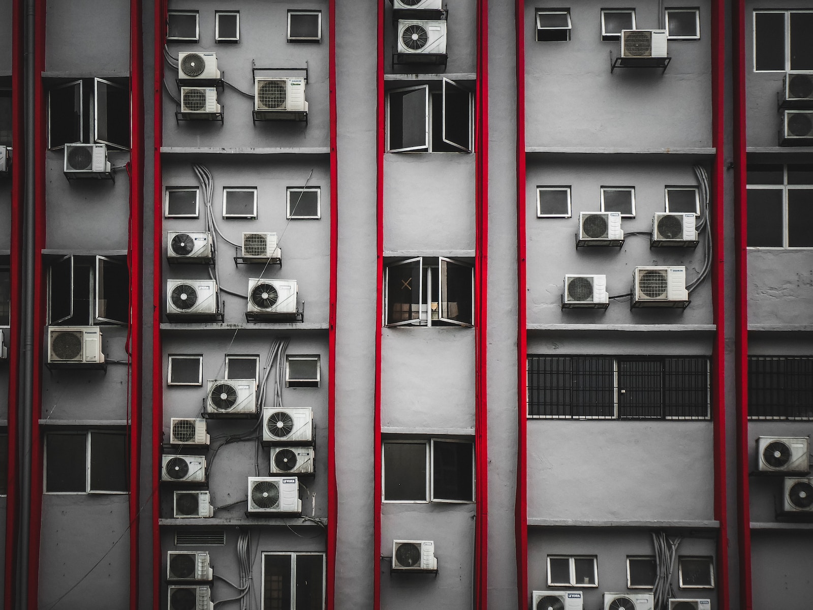 a bunch of air conditioners on a building