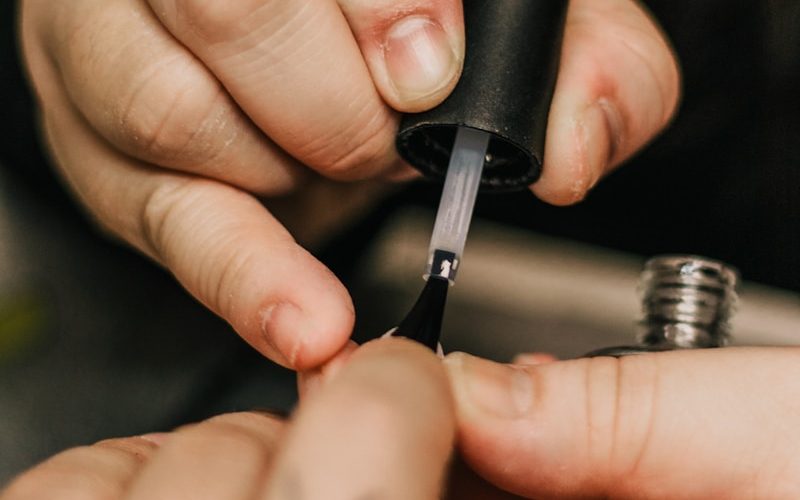 person holding black and silver hand tool